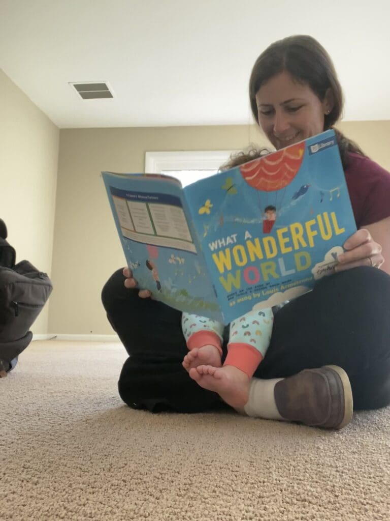 caryn reading book "it's a wonderful world" to daughter in empty room